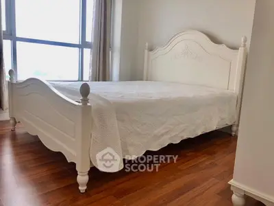 Elegant bedroom with classic white bed and large window view
