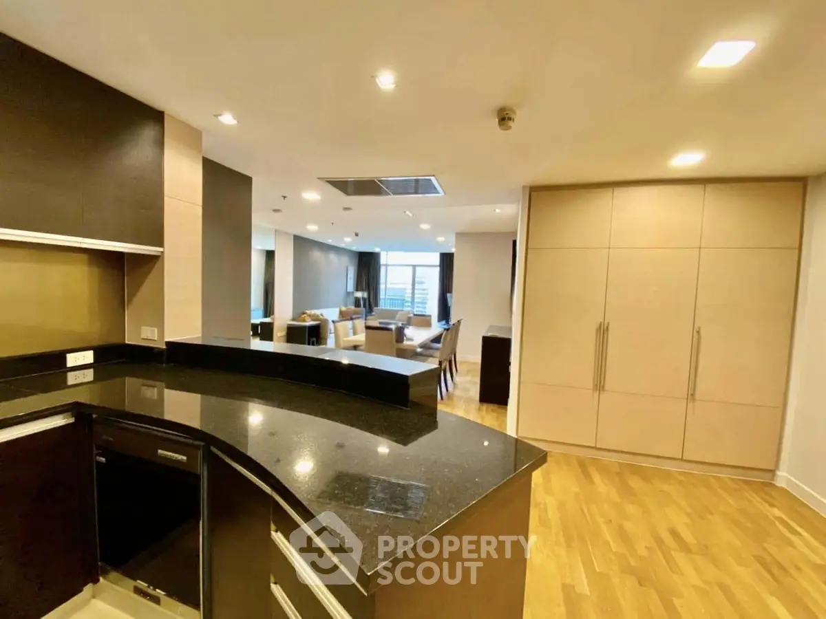 Spacious open-layout kitchen with modern design and hardwood floors