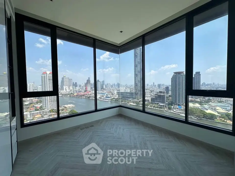 Stunning corner unit with panoramic city and river views, featuring floor-to-ceiling windows and modern flooring.