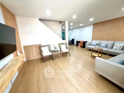 Spacious modern living room with wooden flooring and stylish furniture