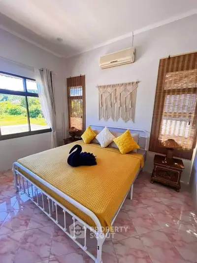 Cozy bedroom with stylish decor and scenic window view