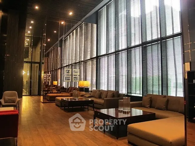 Luxurious modern living room with floor-to-ceiling windows and elegant furnishings.