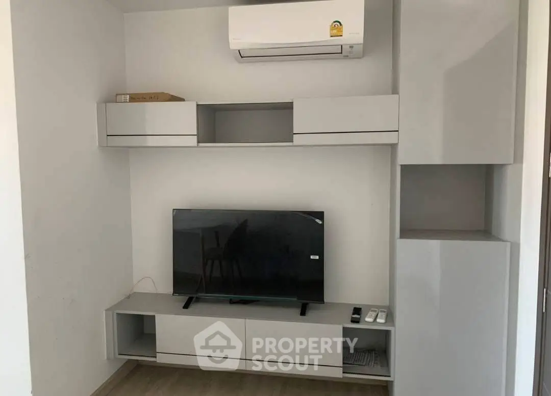 Modern living room with sleek TV unit and air conditioning, perfect for comfortable living.