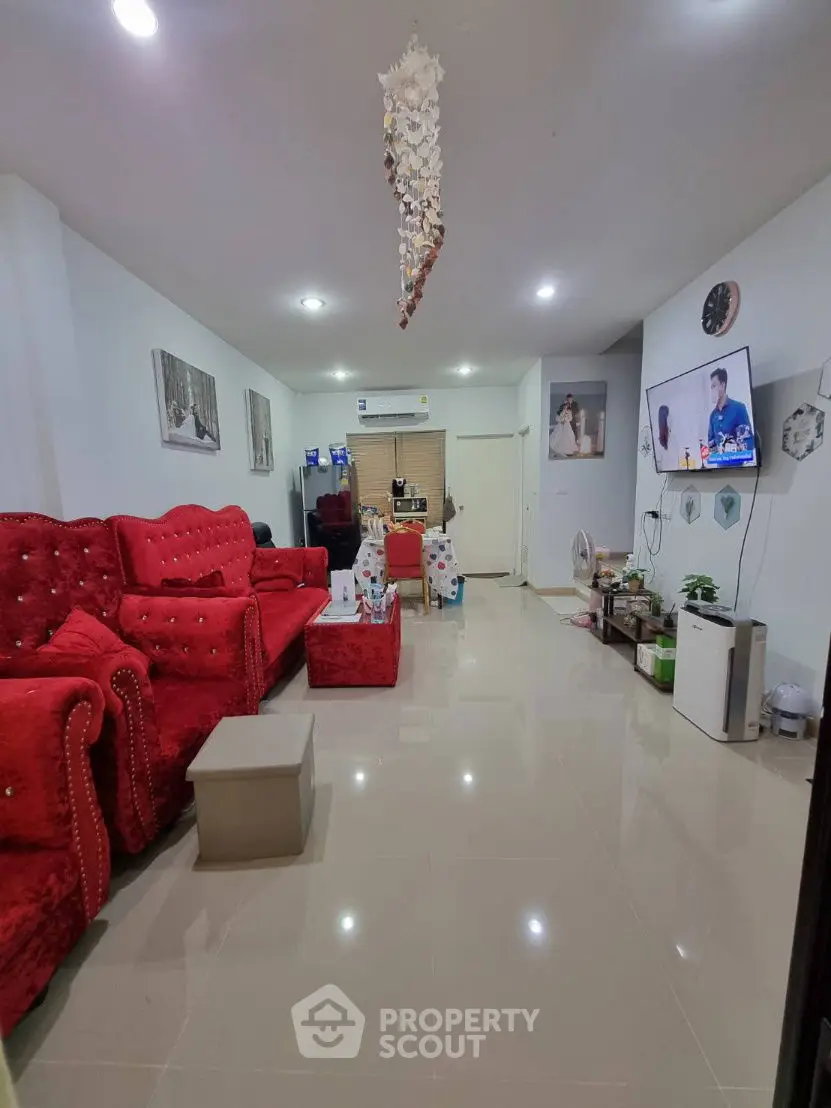Spacious living room with red sofas and modern decor