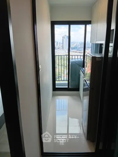 Compact kitchen with city view and modern appliances