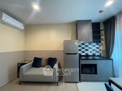 Modern compact living room with kitchenette and stylish decor