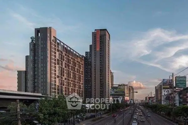 Modern high-rise building with urban skyline and highway view