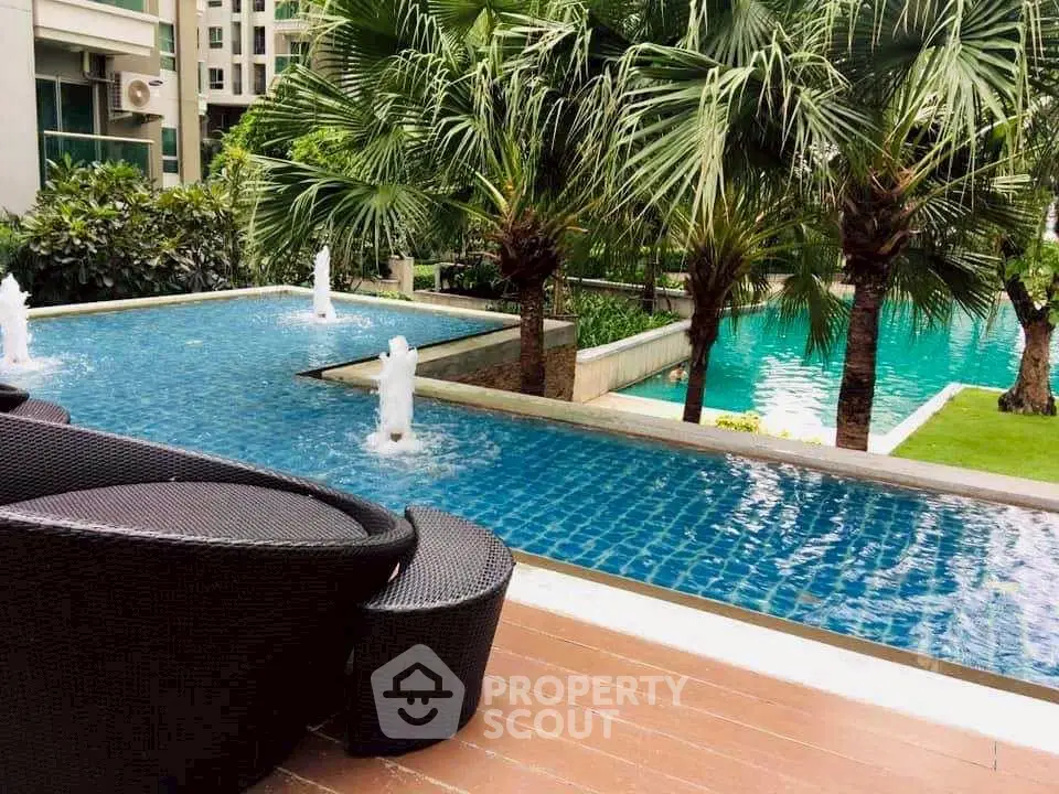 Luxurious poolside view with modern outdoor seating and lush greenery