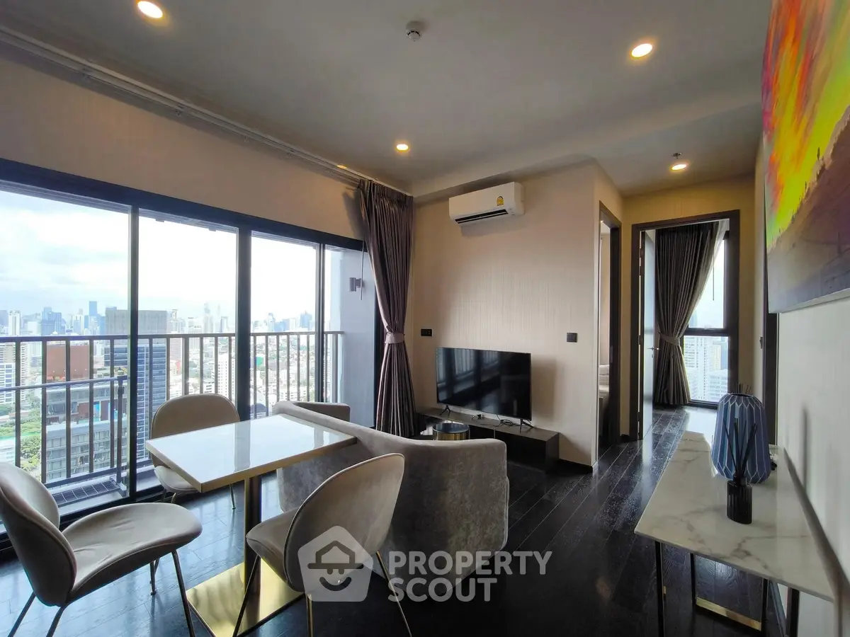 Modern living room with city view and stylish furniture in high-rise apartment.