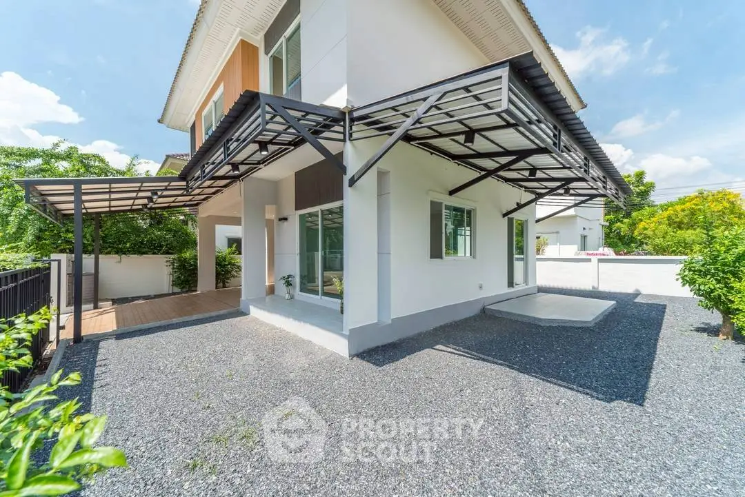 Modern two-story house with spacious outdoor area and sleek design.
