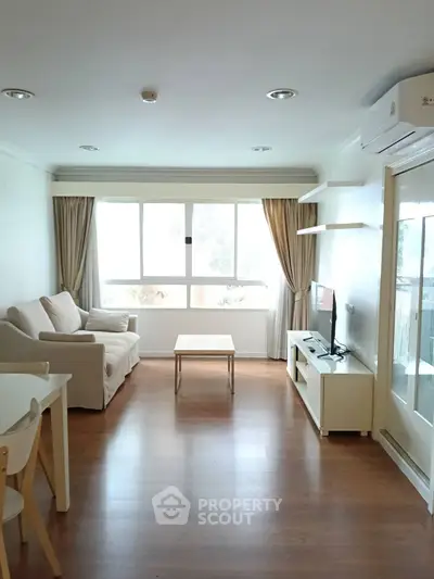 Bright and cozy living room with modern furniture and large window view.