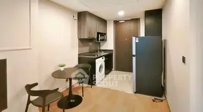 Modern compact kitchen with washing machine and dining area