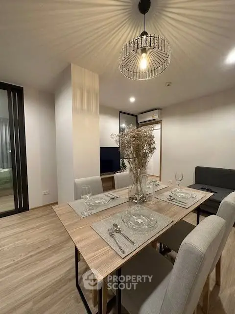 Modern dining area with elegant lighting and stylish decor in a contemporary apartment.
