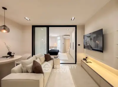 Modern living room with sleek design and open layout, featuring a cozy sofa and wall-mounted TV.