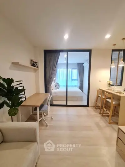 Modern open-plan living area with cozy bedroom view and stylish decor