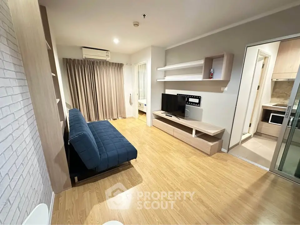Modern living room with wooden flooring, stylish furniture, and natural light.
