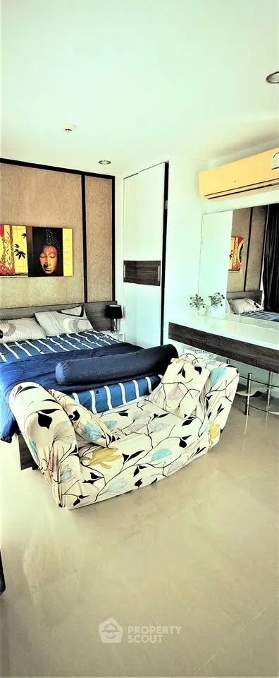 Stylish bedroom with modern decor and cozy seating area in a bright apartment.
