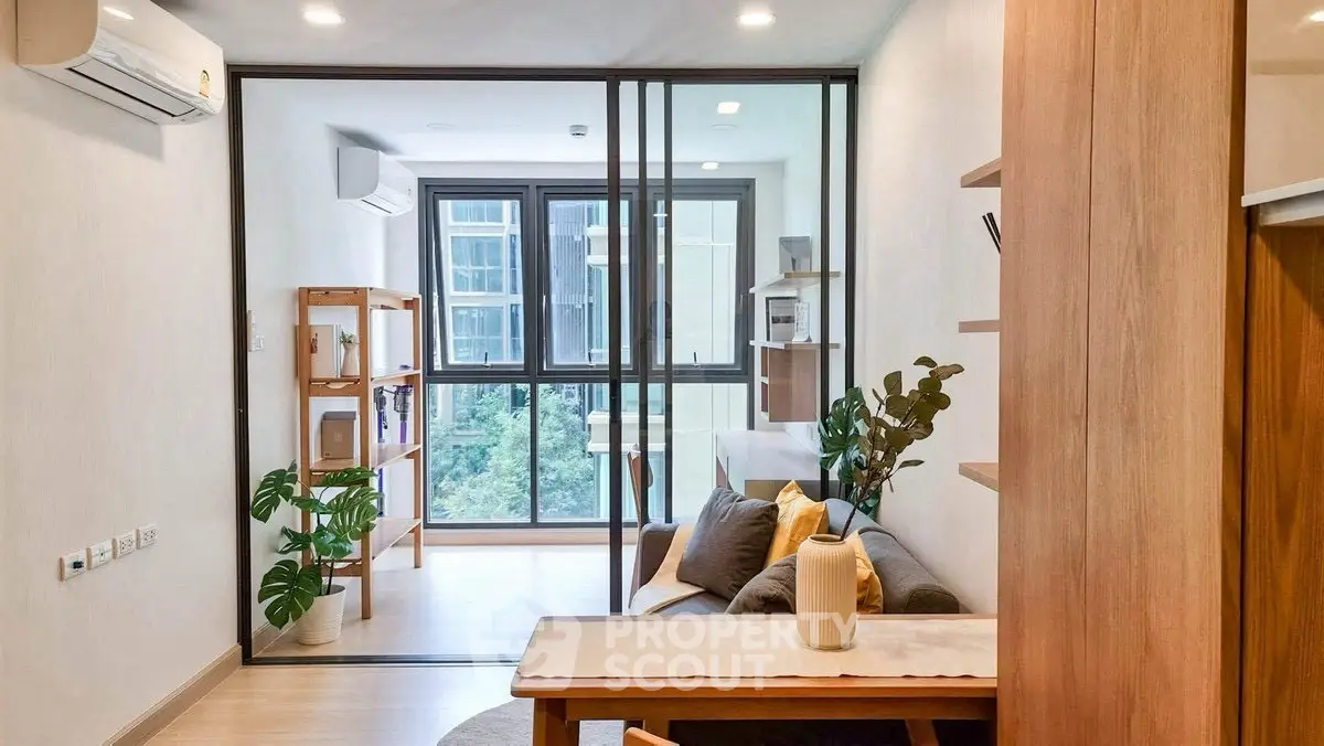 Modern living room with glass partition and natural light
