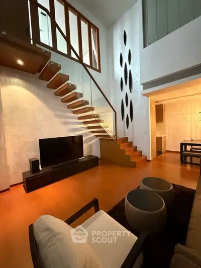 Luxurious modern living room with high ceilings and elegant staircase