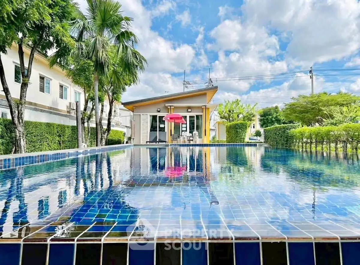 Stunning modern home with a sparkling pool and lush greenery, perfect for relaxation and entertaining.
