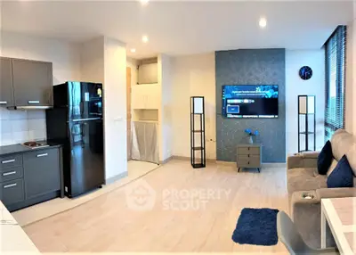 Modern living room with sleek kitchen and stylish decor