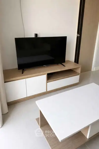 Modern living room with sleek TV stand and minimalist coffee table, perfect for contemporary living spaces.