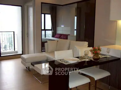 Modern living room with dining area and balcony view in a stylish apartment.