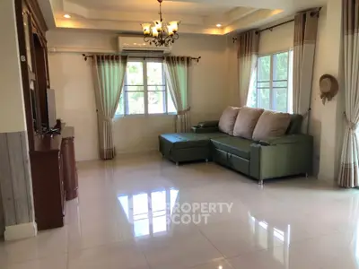 Spacious living room with elegant chandelier and large windows