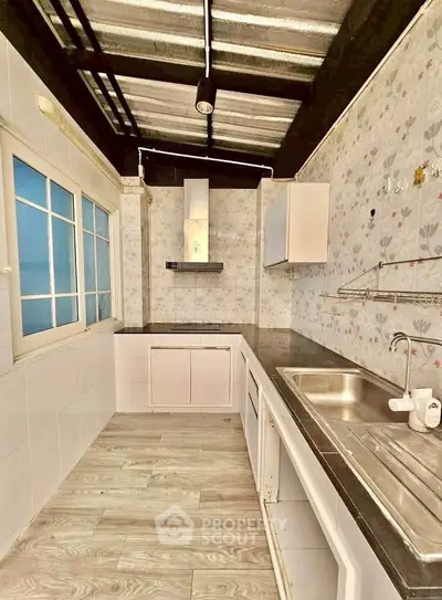 Modern kitchen with sleek countertops and ample natural light