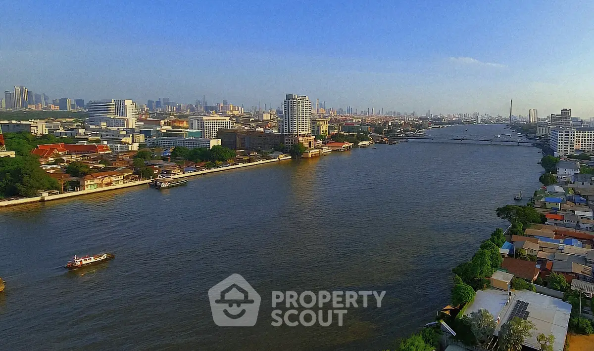 Stunning river view of urban skyline with vibrant cityscape and serene waters.