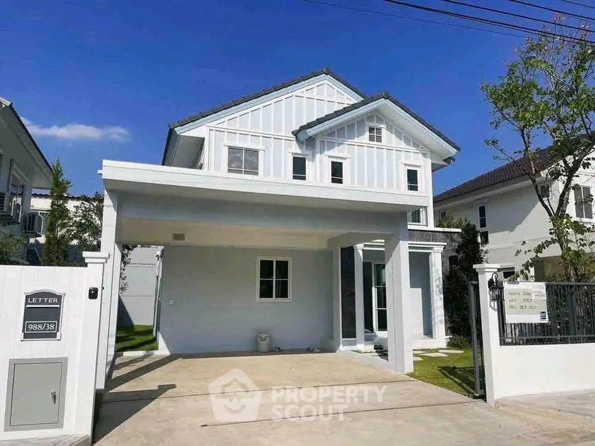 Charming two-story house with modern design and spacious driveway in a serene neighborhood.