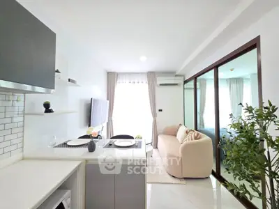 Modern open-plan living room with sleek kitchen and cozy seating area