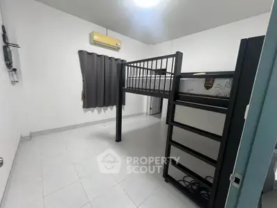 Spacious bedroom with loft bed and air conditioning, ideal for maximizing space and comfort.
