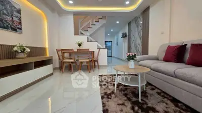 Modern living room with elegant decor, cozy seating, and stylish dining area in open layout.