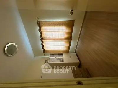 Spacious empty bedroom with wooden flooring and natural light