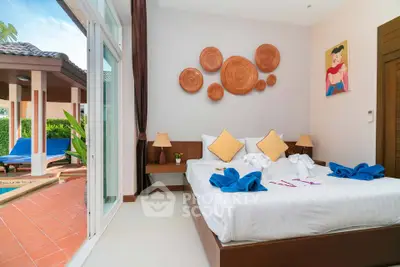 Luxurious bedroom with poolside view and artistic decor in tropical villa