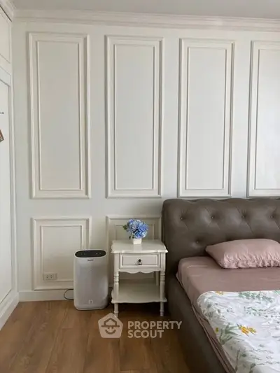 Elegant bedroom with classic panel walls and cozy bed setup