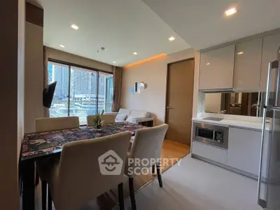 Modern open-layout living room and kitchen with city view, featuring sleek furniture and contemporary design.