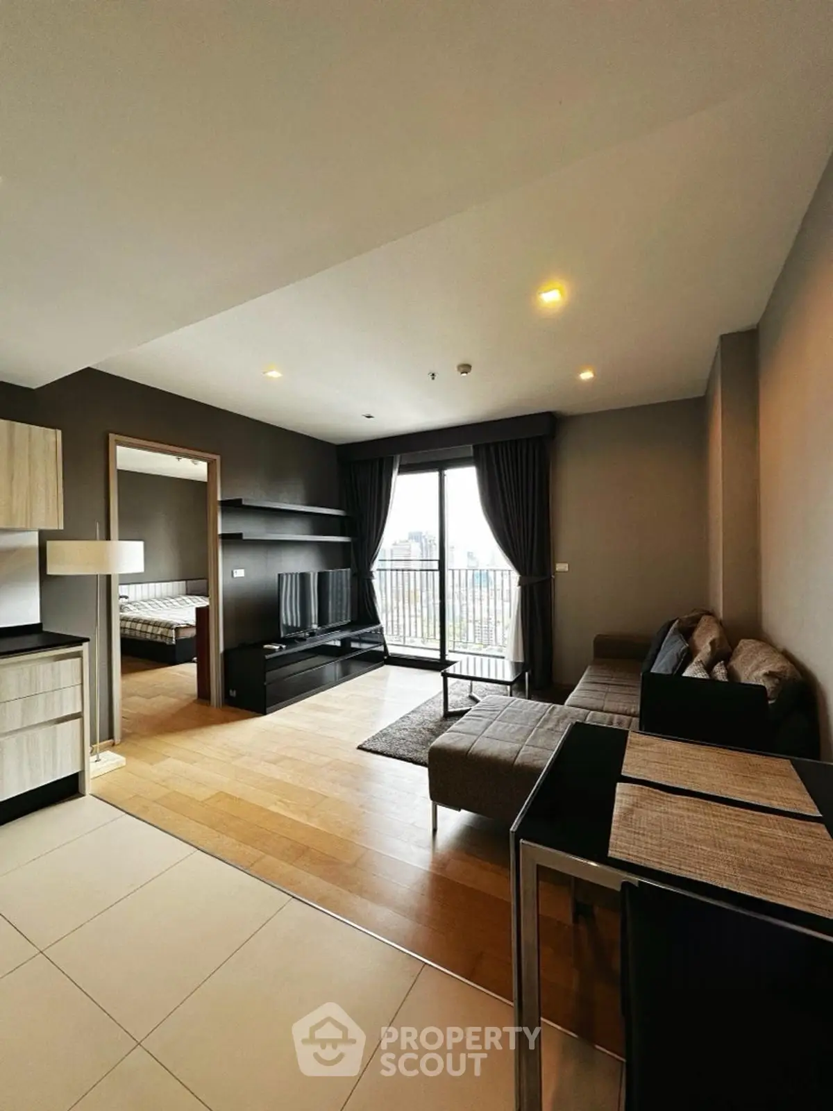 Modern living room with open layout and balcony view in stylish apartment
