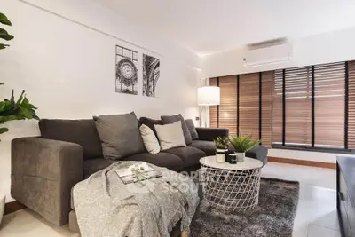 Modern living room with cozy gray sofa and stylish decor