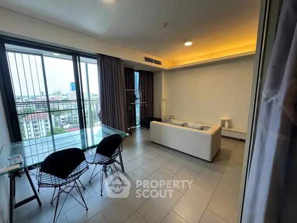 Spacious modern living room with city view and elegant furnishings.