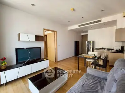 Modern living room with open kitchen and sleek furniture design