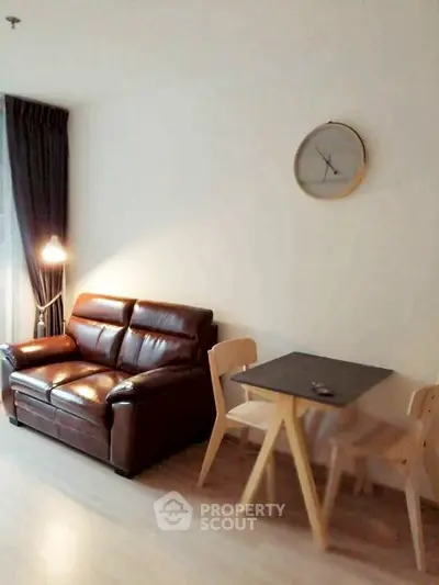 Cozy living room with leather sofa and modern dining set