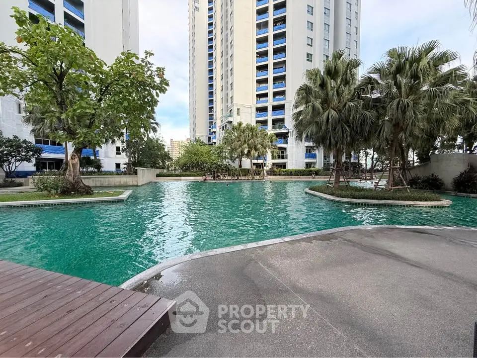 Luxurious residential complex with stunning pool and lush greenery