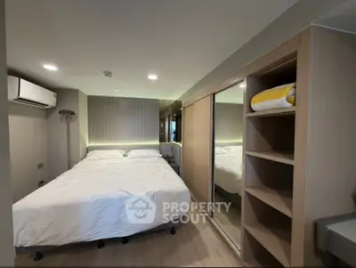 Modern bedroom with mirrored closet and cozy lighting in stylish apartment