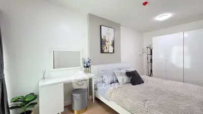 Modern bedroom with stylish decor and cozy bedding in a bright apartment.