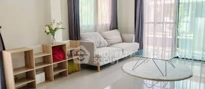 Bright and modern living room with stylish furniture and large windows.