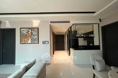 Modern living room with sleek design and elegant decor, featuring a comfortable sofa and stylish artwork.