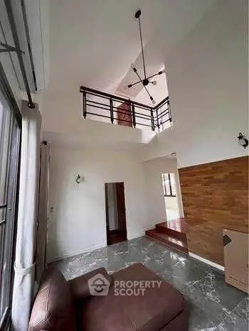 Spacious living room with high ceiling and modern design