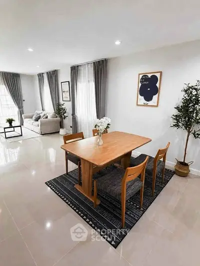 Spacious modern living and dining area with elegant decor and natural light.